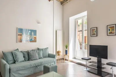 a living room with a couch and a tv at MetaM Apartment in the City Center by Wonderful Italy in Palermo