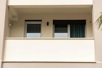 a building with two windows and a fence at Bagheria Home in Bagheria