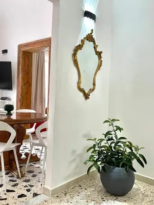 a mirror on the wall of a living room with a plant at City SEA DOWNTOWN in Palermo