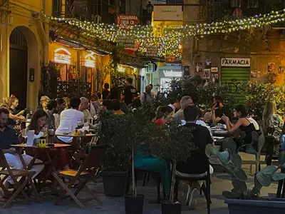 people sitting at tables in a restaurant at night at City SEA DOWNTOWN in Palermo