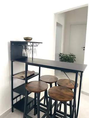 a black counter with stools under it with a table at City SEA DOWNTOWN in Palermo