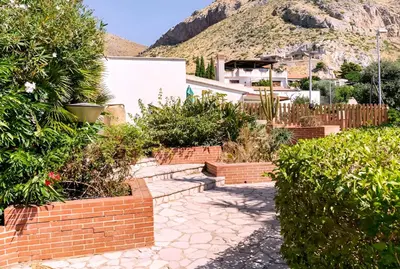 a garden with a brick path and bushes at Casa Giulù- in Palermo