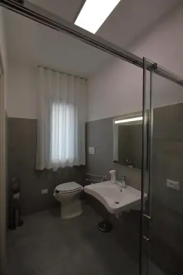 a bathroom with a toilet and a sink and a shower at villa grecale in Castellammare del Golfo