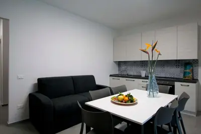 a living room with a table and a couch at villa grecale in Castellammare del Golfo