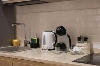 a kitchen counter with a mixer and glasses on it at Il Sipario Luxury Apartments in Palermo