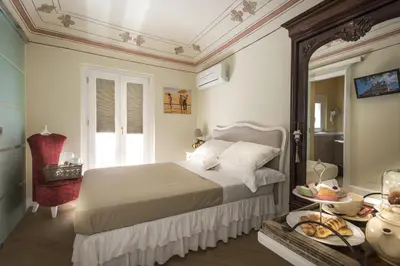 a bedroom with a bed and a table with food on it at Pane Amore e Marmellata in Palermo