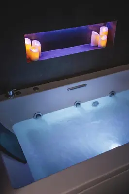 a bathroom sink with candles on top of it at AQUAROOMS Suites in Palermo