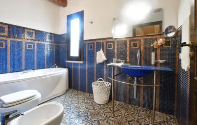 a bathroom with a tub and a toilet and a sink at Cozy Home In Partinico With Wifi in Partinico