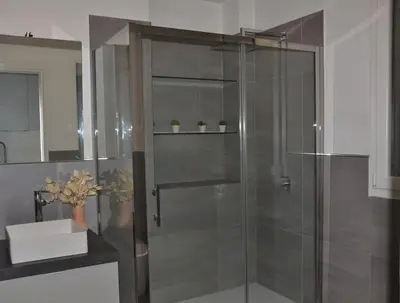 a shower with a glass door in a bathroom at Little Loft 39 in Palermo