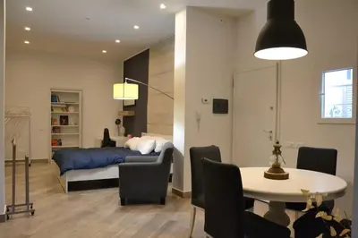 a bedroom with a bed and a table and chairs at Little Loft 39 in Palermo