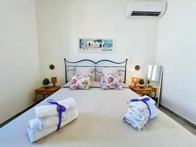 a bedroom with a large bed with towels on it at Stella Marina in Carini