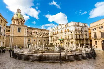 a fountain in front of a building with a dome at Stella Marina in Carini