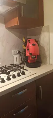 a red helmet sitting on top of a stove in a kitchen at Home Sweet Home in Palermo