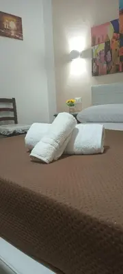 two beds with white pillows on top of them at Home Sweet Home in Palermo