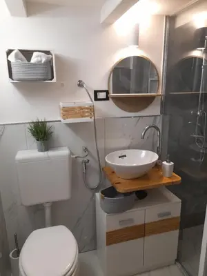 a bathroom with a toilet and a sink and a mirror at Sweet home Palermo in Palermo