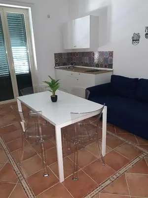 a white table and chairs in a living room at Central Station in Palermo