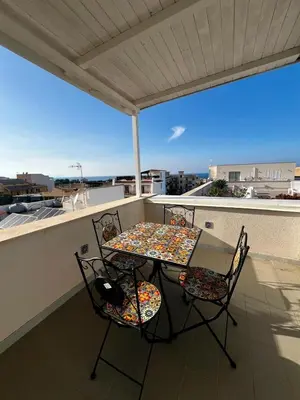 a table and chairs on a balcony with a view at Mari Sol in Terrasini