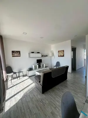 a living room with a couch and a table and chairs at Mari Sol in Terrasini