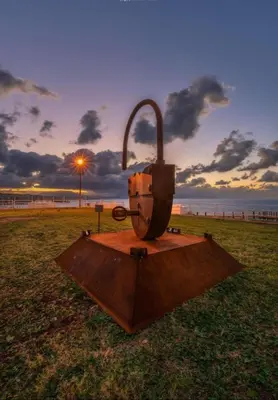 a sculpture of the gateway arch in a field at Mari Sol in Terrasini