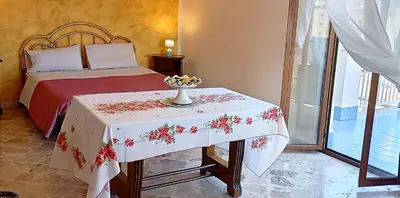a bedroom with a bed with two chairs at Apartament di Nick Central Station No ZTL in Palermo