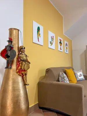 a living room with a couch and a gold object at Ai Pupi Siciliani in Palermo