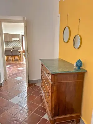 a room with a dresser and two mirrors on the wall at Ai Pupi Siciliani in Palermo