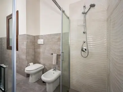 a bathroom with a toilet and a sink and a shower at Villa Rocchi Livreri by Interhome in Scopello