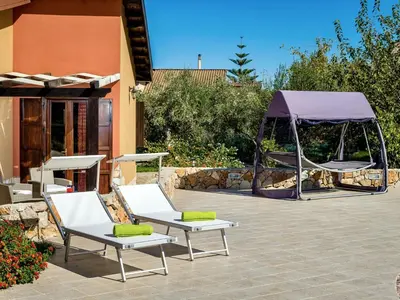 a patio with two lounge chairs and a gazebo at Villa Flavia by Interhome in Castellammare del Golfo