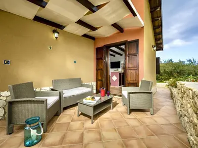 a patio with chairs and a couch and a table at Villa Flavia by Interhome in Castellammare del Golfo