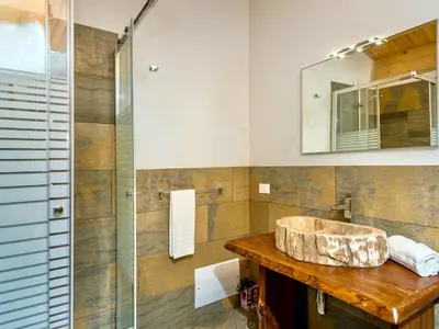 a bathroom with a sink and a glass shower at Villa Le Muse by Interhome in Scopello