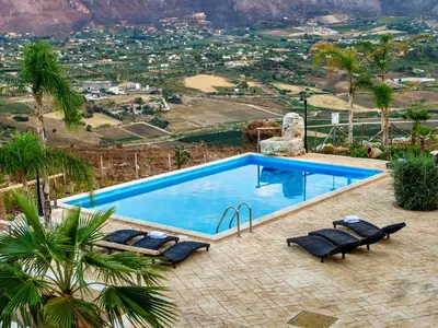 a swimming pool with a view of a mountain at Villa Le Muse by Interhome in Scopello