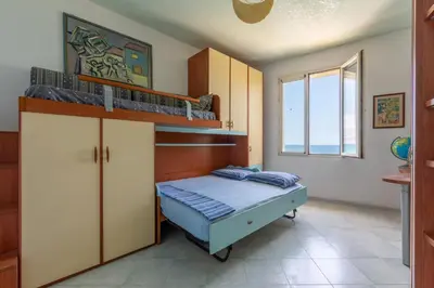 a bedroom with two bunk beds and a window at Villetta Ficarazzi by Wonderful Italy in Ficarazzi