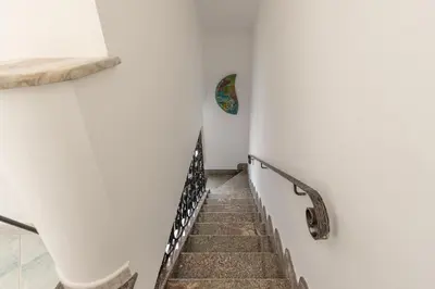 a stairway in a room with a white wall at Villetta Ficarazzi by Wonderful Italy in Ficarazzi