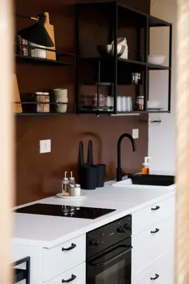 a kitchen with white counters and a black stove at Casa Donna Pippina in Villafrati