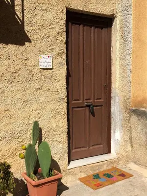 a door to a building with a cactus in front of it at Casa Donna Pippina in Villafrati
