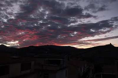 a cloudy sky at sunset with mountains in the background at Casa Donna Pippina in Villafrati