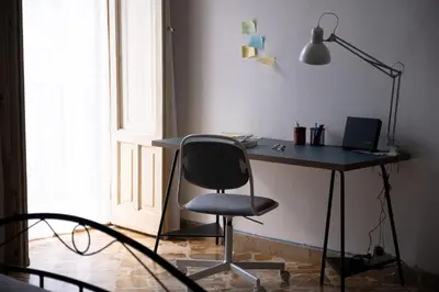 a desk with a chair and a lamp in a room at Casa Donna Pippina in Villafrati