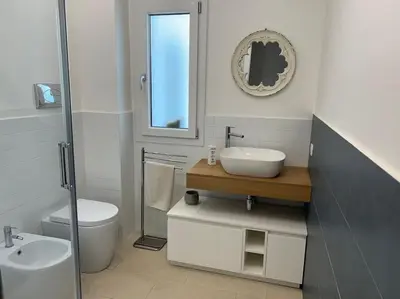 a white bathroom with a sink and a toilet at Villa Lucia in Palermo