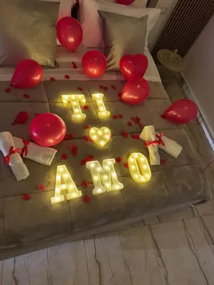 a bed with hearts and a sign that says kiss at Raquel suite and SPA in Palermo