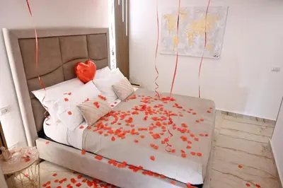 a bedroom with a bed with red hearts on it at Raquel suite and SPA in Palermo
