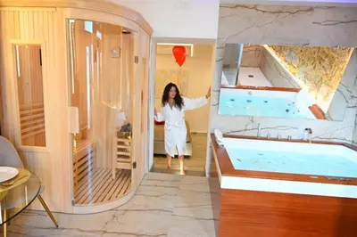 a woman standing in a bathroom with a tub at Raquel suite and SPA in Palermo