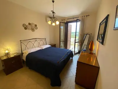 a bedroom with a large bed and a window at Amarena Casa Vacanze in San Vito lo Capo