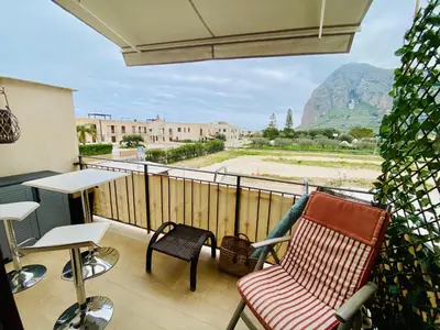 a living room with a table and a tv at Amarena Casa Vacanze in San Vito lo Capo
