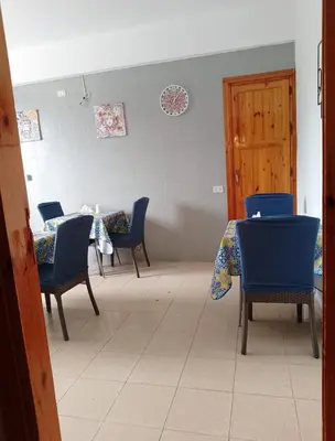 a waiting room with blue chairs and a table at Villa Buscemi in Bagheria