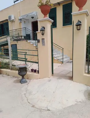 a building with a staircase and a vase on top of it at Villa Buscemi in Bagheria