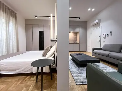 a bedroom and a living room with a bed and a couch at Palazzo Giglio suite in Palermo