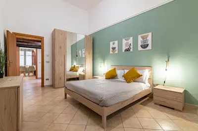 a bedroom with a bed with yellow pillows at GuestHost - Your Home at the Cathedral - Palermo Cozy Flat in Palermo