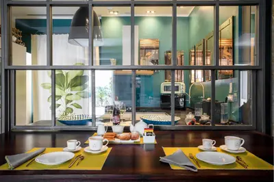 a table with plates and utensils on top at Trinacria Luxury Suite in Palermo