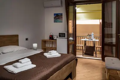 a bedroom with a bed with towels on it at Sofia Rooms in Castellammare del Golfo