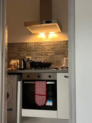 a kitchen with a stove with a towel on the oven at Alfa & Omega apartments in Palermo